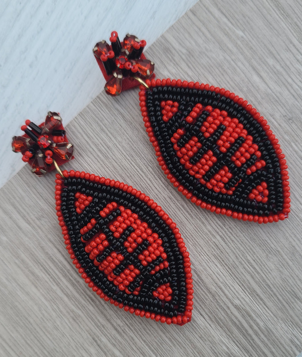 RED AND BLACK SEED BEAD FOOTBALLS